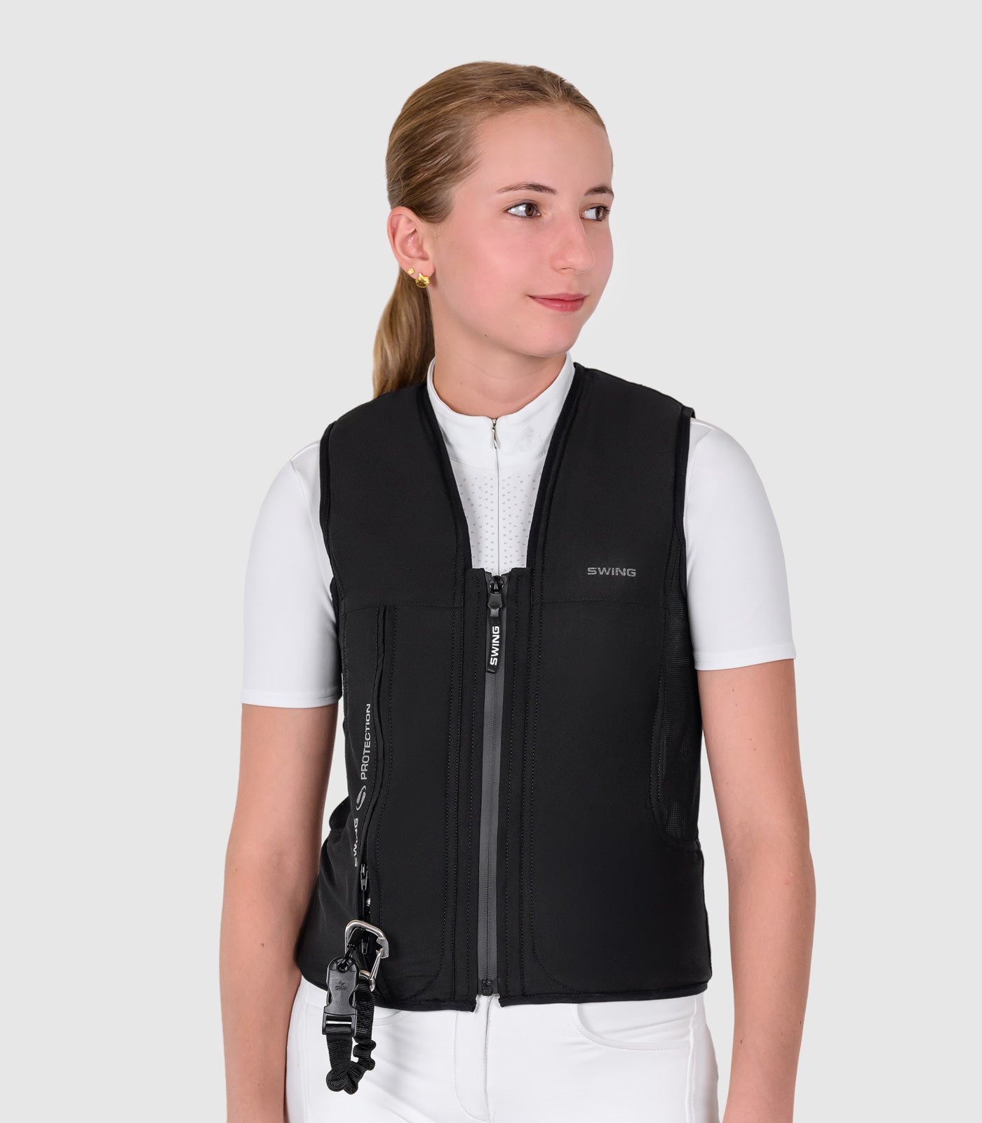 Person wearing a black equestrian vest on a white background